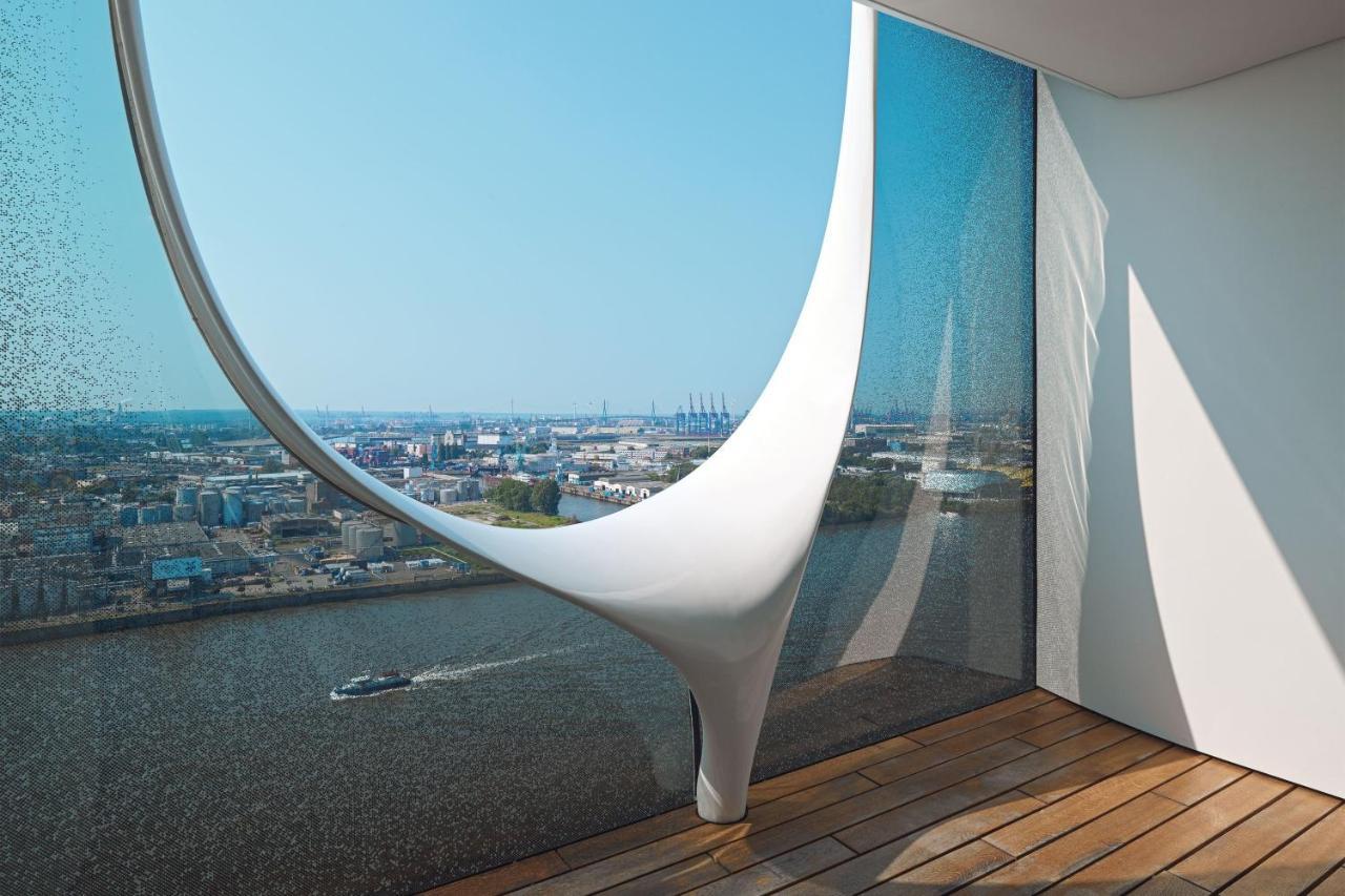 The Westin Hamburg Elbphilharmonie Hotel Luaran gambar The photo showcases a modern architectural interior featuring a large, uniquely designed window that creates a dramatic visual effect. The window has an organic, flowing shape, resembling a sculptural element, and is made of glass that allows natural