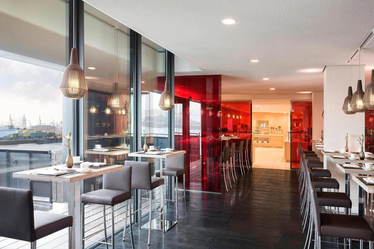 The Westin Hamburg Elbphilharmonie Hotel Luaran gambar The photo showcases a modern restaurant interior characterized by sleek design and contemporary decor. The space features a combination of large windows allowing natural light to filter in, creating an open and airy atmosphere. The walls are accented