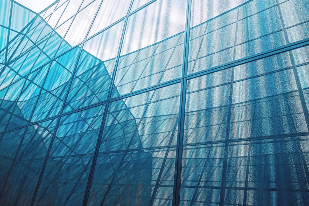The Westin Hamburg Elbphilharmonie Hotel Luaran gambar The photo shows an architectural structure with a facade made of glass. The glass panels are arranged in a way that creates a reflective and translucent effect, with various shades of blue dominating the image. The interplay of light and shadow creat